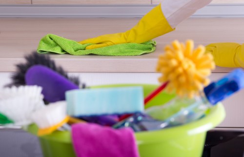 Cleaner tidying a kitchen during a Surrey domestic cleaning visit