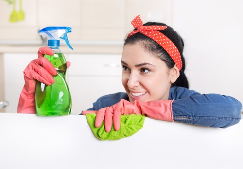 Professional cleaner applying safe cleaning practices in a Surrey property