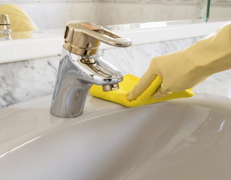 Local Surrey cleaner handling a short-let kitchen and bathroom turnover